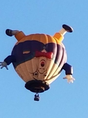 A hot air balloon with a clown on it.