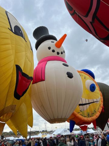 A group of balloons with a snowman on them.