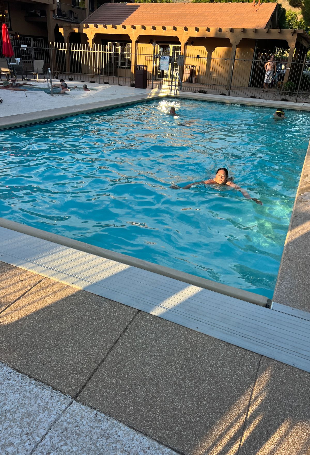 A person is swimming in a pool.