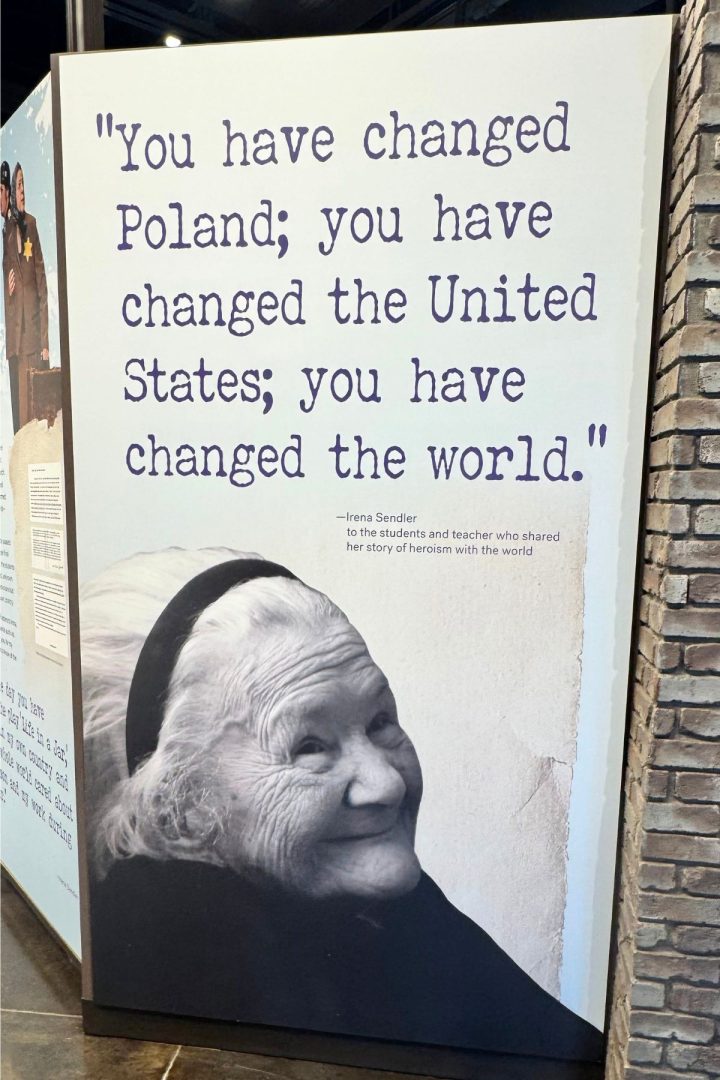 A large display featuring a black-and-white photo of Irena Sendler and a quote about changing Poland, the United States, Southeast Kansas, and the world, attributed to her.