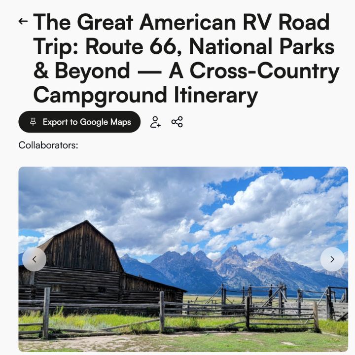 Old wooden barn with a mountain range and cloudy blue sky in the background; perfect scenery for an RV road trip, with fencing and grassy field in the foreground.